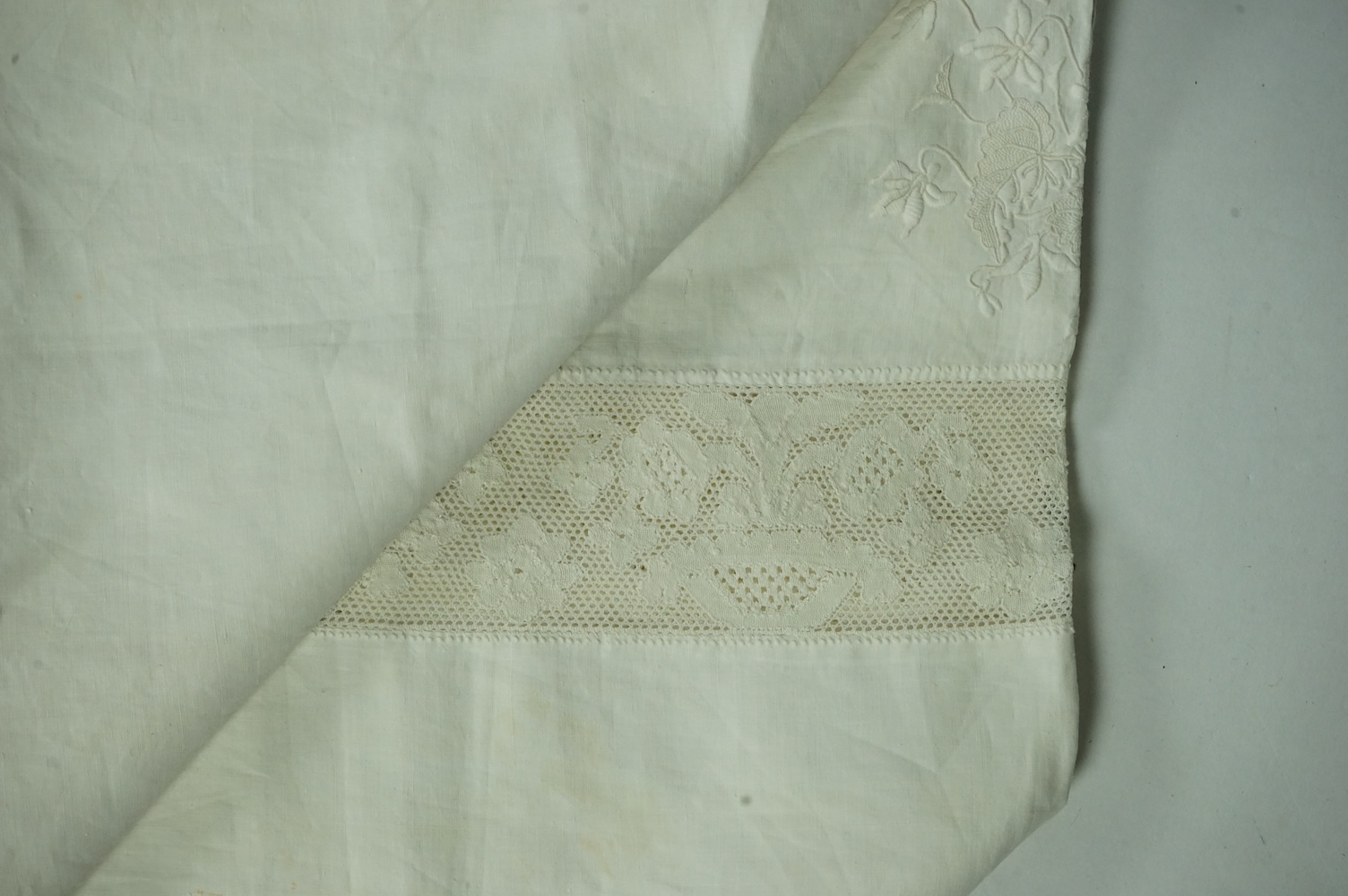 An unusual Victorian white linen hand worked table cloth. Embroidered along one edge, Wrought by L. Grover for her daughter Ethel Frances Burbury 1895. Together with three crochet edged cloths and a circular embroidered